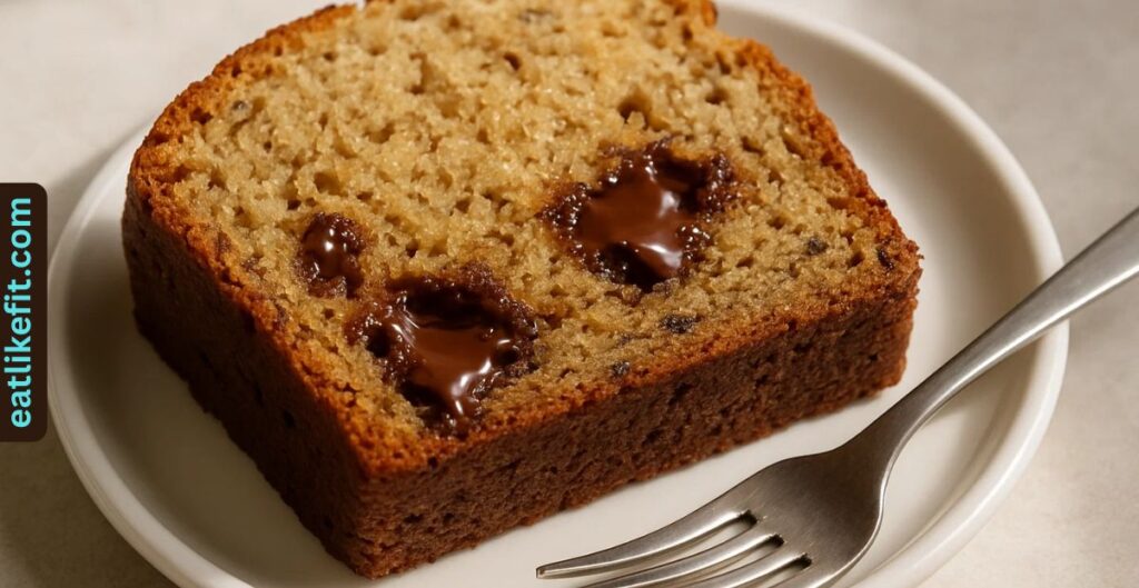 Chocolate chip banana bread slice served on a plate.