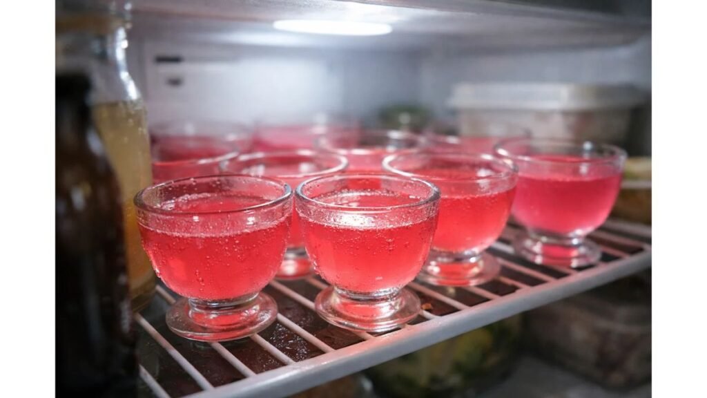 Pink gelatin dessert cups chilling in refrigerator to set low calorie dessert