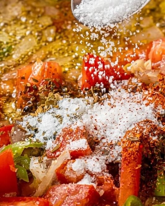 Pour in your diced fresh tomatoes along with your salt, red chili flakes, and ground cumin