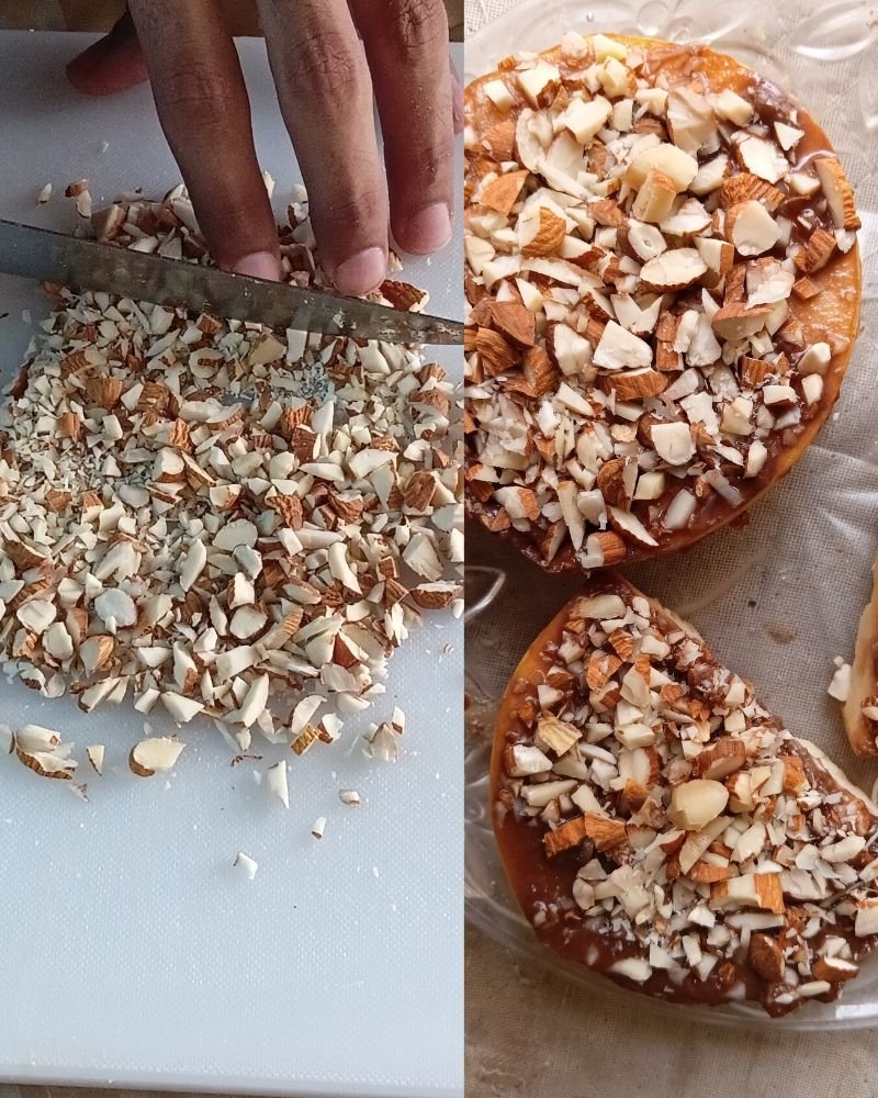 Chopping raw whole almonds with a knife on a white cutting board for a healthy snack recipe