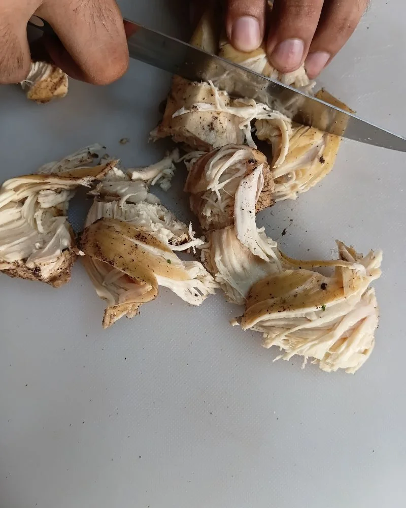 Cut the cooked chicken breast into evenly sized bite-sized cubes
