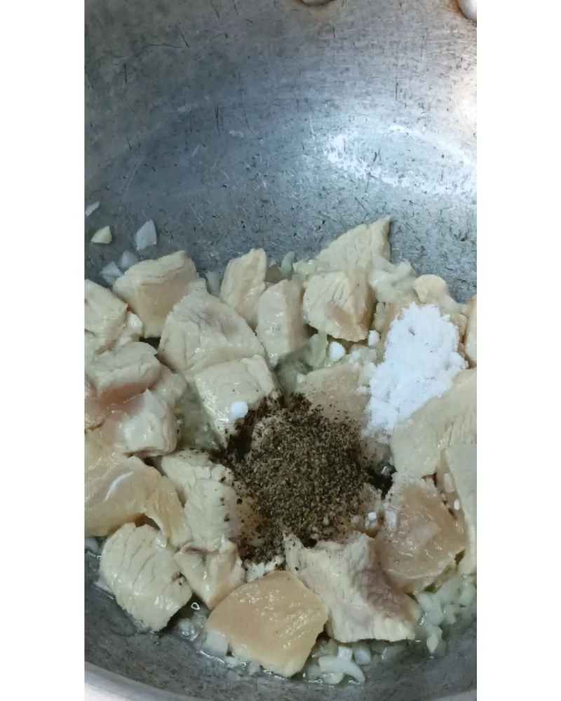 Add the cubed chicken in a single layer. Season with salt and black pepper.