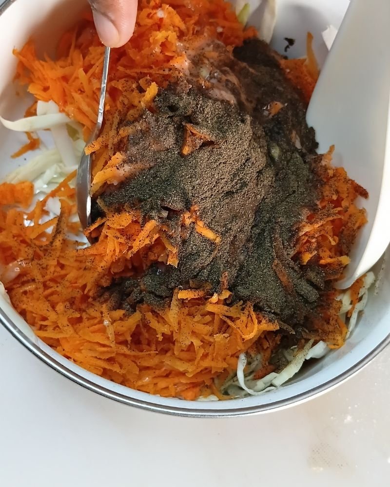 Pour the dressing over the cabbage and carrots